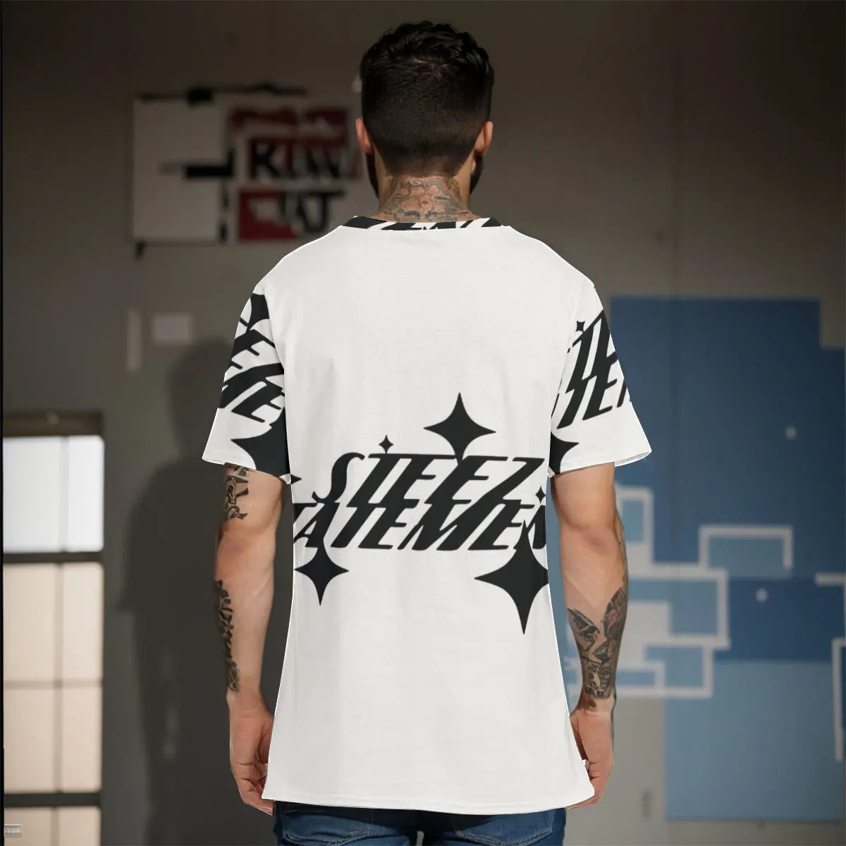 Back view of a man wearing a stylish graphic T-shirt with black and white design, showcasing modern fashion trends.