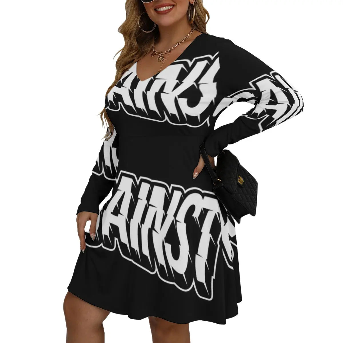 Woman wearing long sleeve Bell Dress with V-neck, black microfiber fabric, bold white print, accessorized with a stylish handbag. Size L to 5XL.