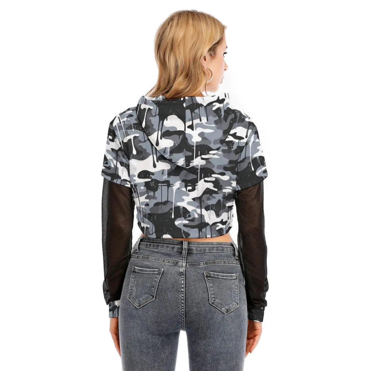 Back view of a woman wearing a camo layered crop top with mesh sleeves and hoodie, paired with jeans.