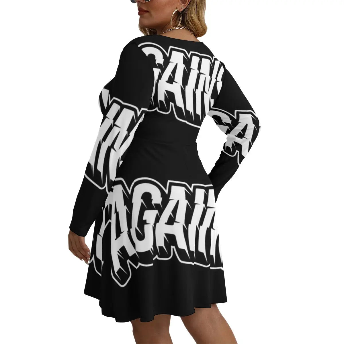 Woman wearing black Bell Dress with bold white text, long sleeves, and V-neck, crafted from soft microfiber, ideal for layering.