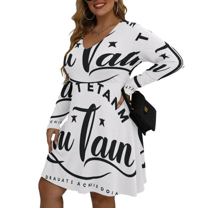 Woman wearing Bell Dress with V-neck and long sleeves, featuring bold print design, paired with a black bag for a stylish look.