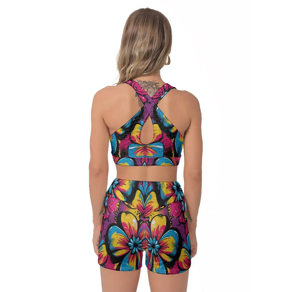 Back view of model wearing colorful gym set with floral pattern, featuring a sports bra and shorts, perfect for yoga or parties.