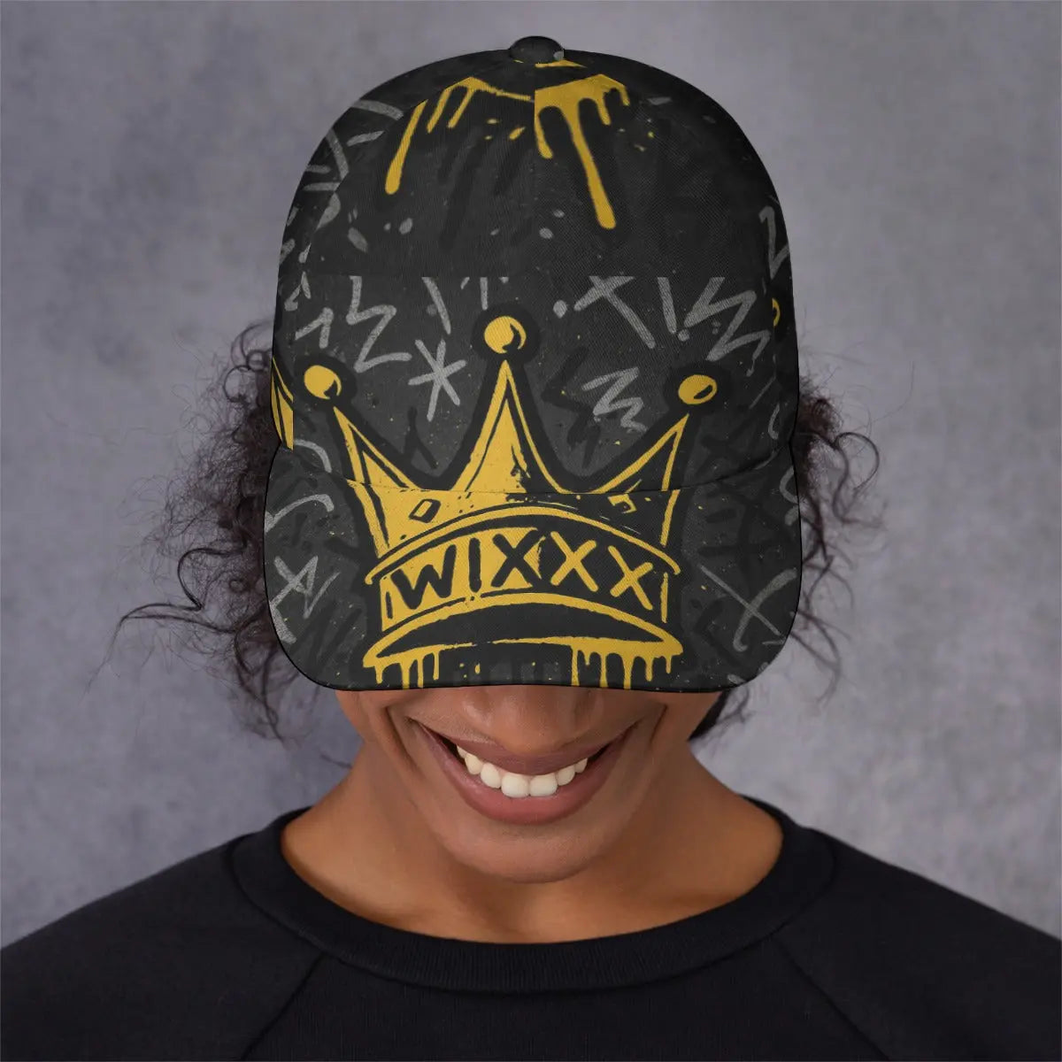 Person wearing a black cap with yellow crown design and 'WIXXX' text on a gray background