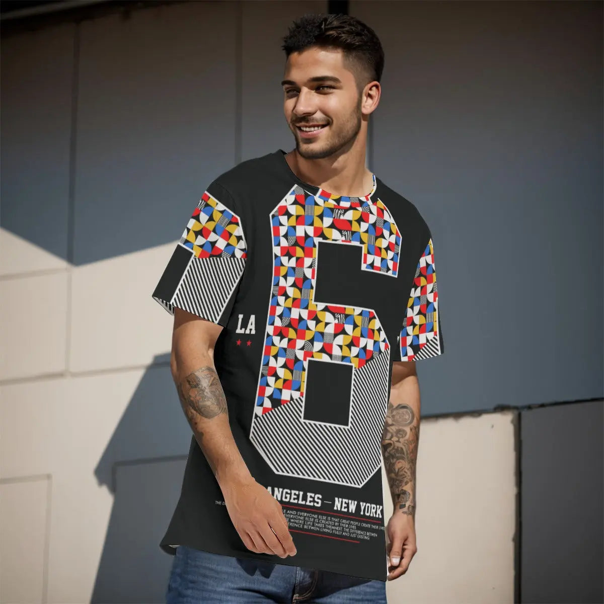 Young man wearing a colorful geometric-patterned T-shirt with number 6 print, showcasing casual summer streetwear fashion.