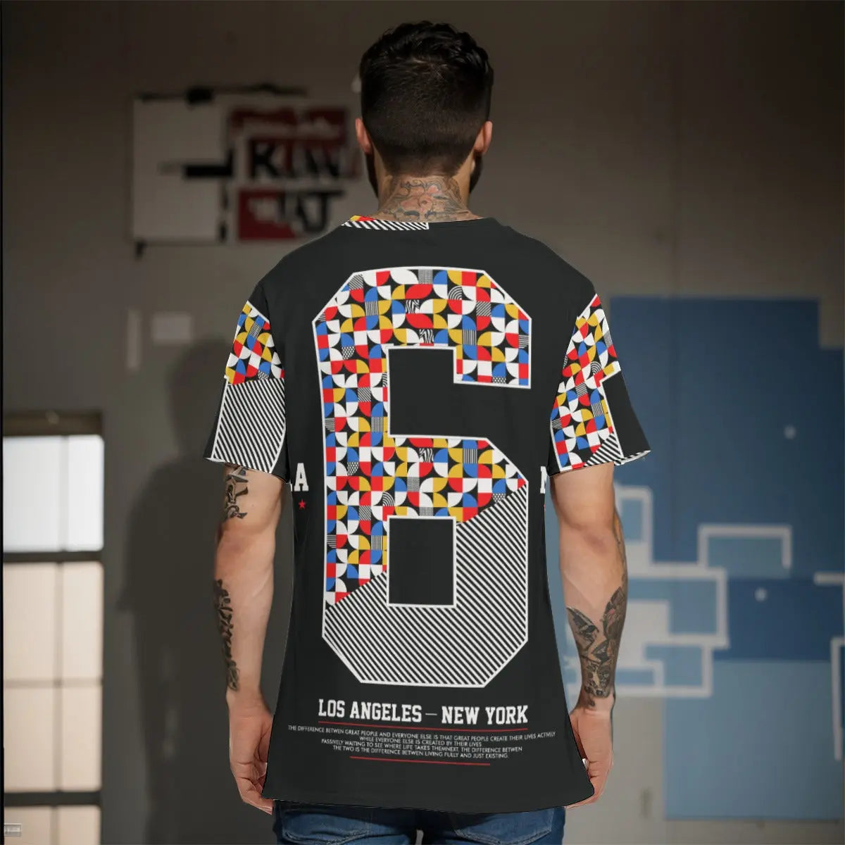Man wearing a designer shirt with colorful geometric pattern and number six on the back, styled for urban fashion.