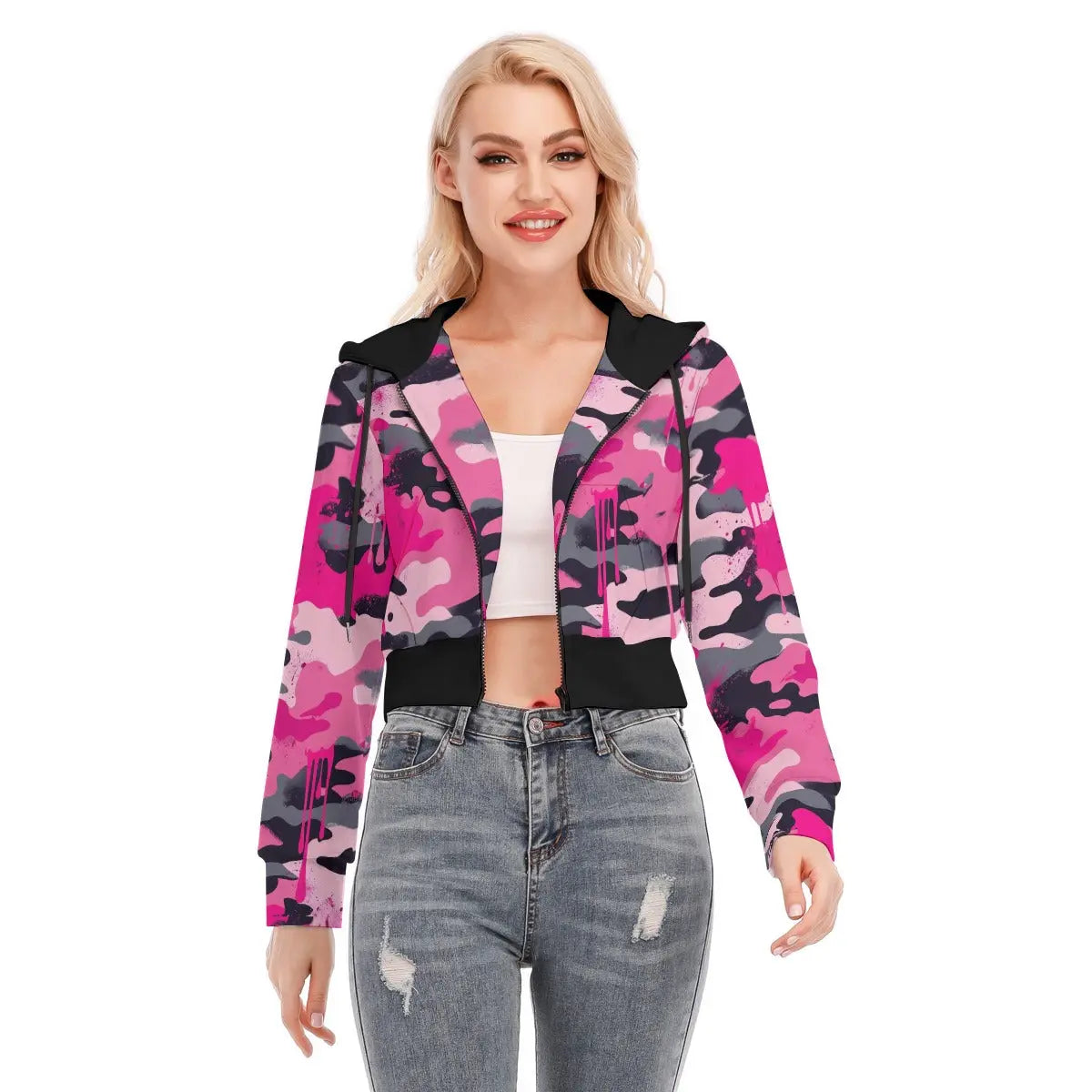 Woman wearing a pink camo cropped jacket with zipper closure, showcasing long sleeves and a comfortable fit, paired with jeans.