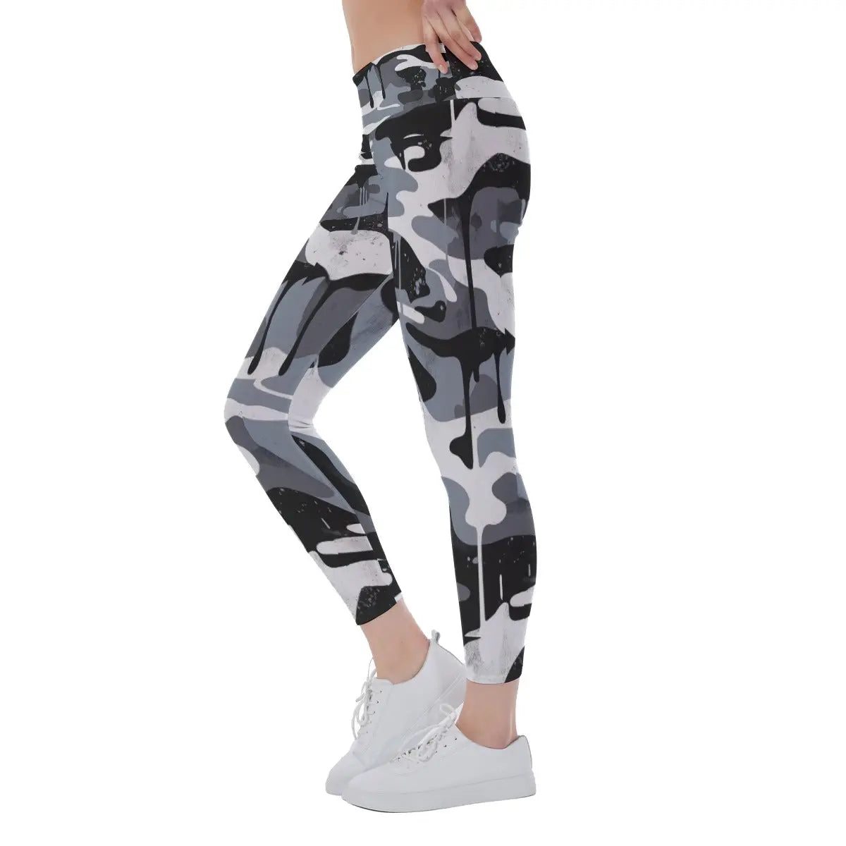 Woman wearing black and white camo yoga leggings with white sneakers, side view