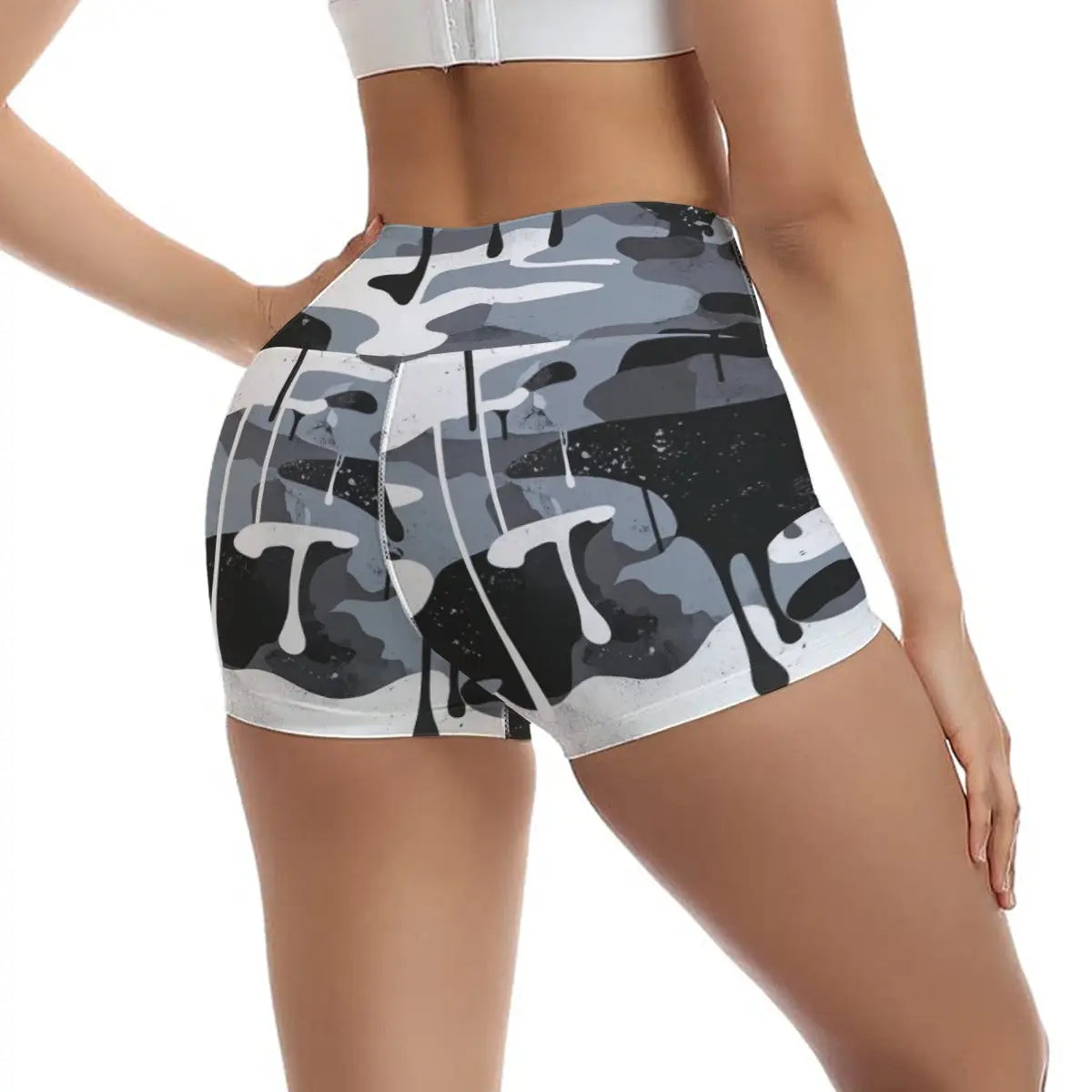 Woman wearing camo yoga shorts, showcasing comfort and flexibility with stretchy polyester-spandex fabric, perfect for sports activities.
