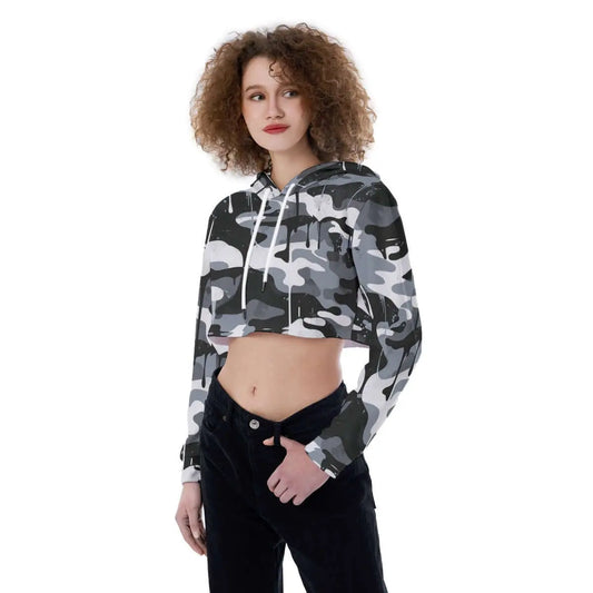 Woman wearing a camo print cropped hoodie with a drawstring hood and long sleeves, styled casually with black pants.